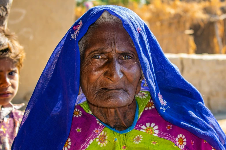 an old woman with a blue head piece