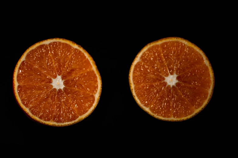 an orange is cut in half and laying flat