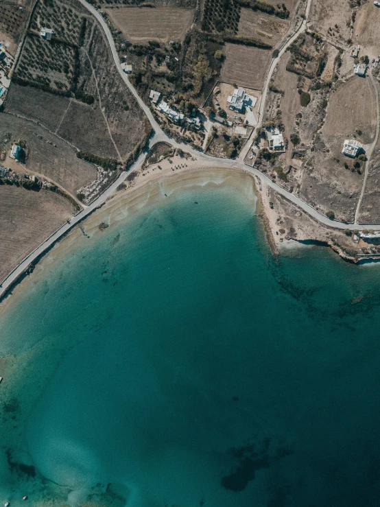 a blue body of water near a hillside