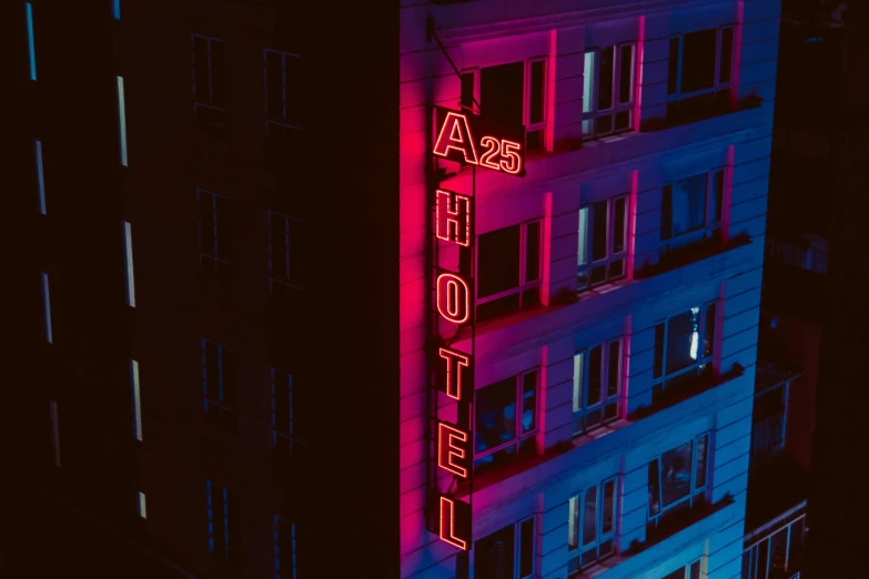 a neon sign lit up the side of a building