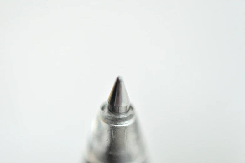 a metal tip of an electronic device on white surface