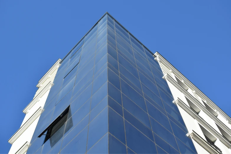 a blue glass building with two windows below