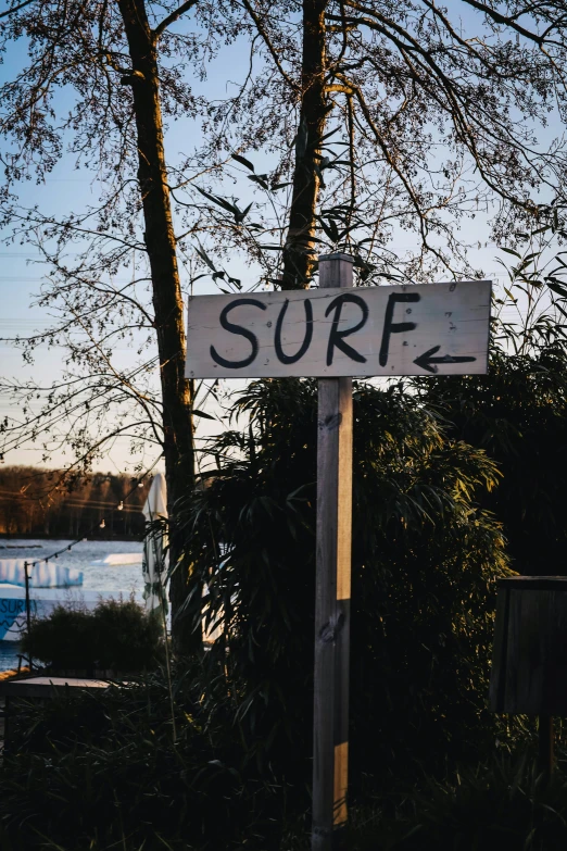 the surf sign is pointing right at an angle