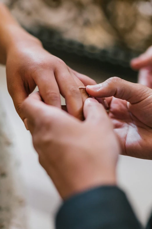 man and woman are exchanging their rings in their hands