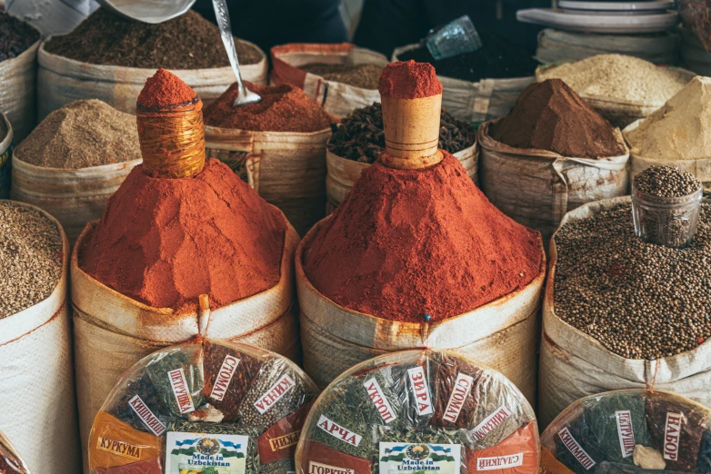 bags filled with various spices sitting on top of each other