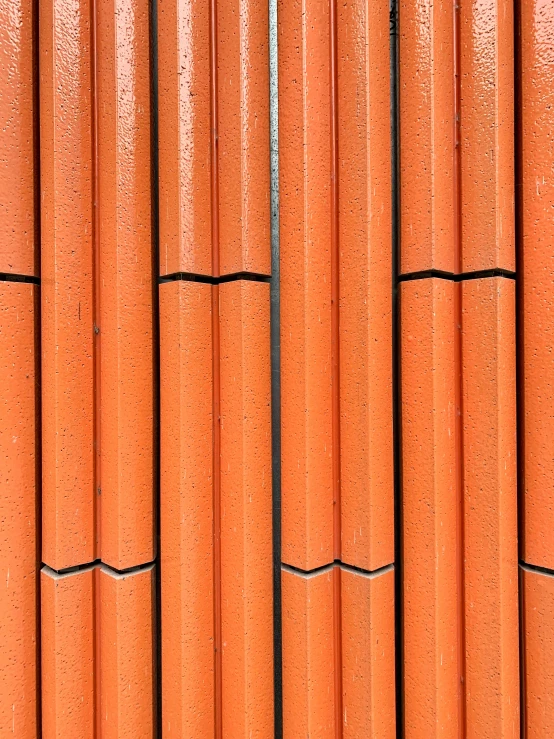 an orange row of concrete pillars made out of bricks