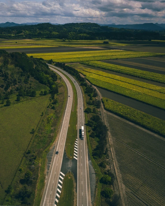 a country road and highway passing through the fields