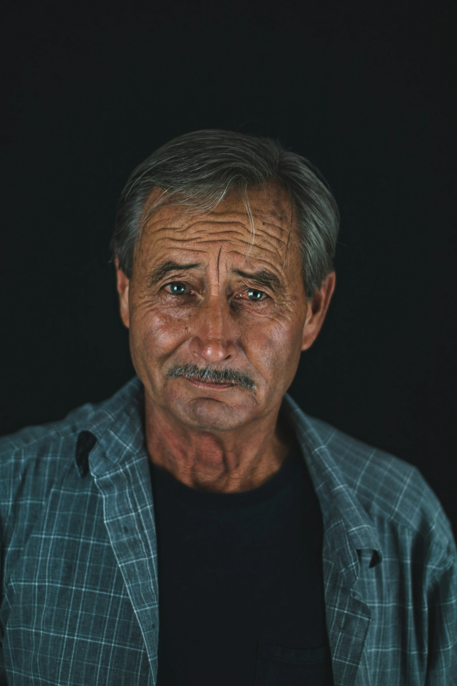 a portrait of a man with a mustache and suit