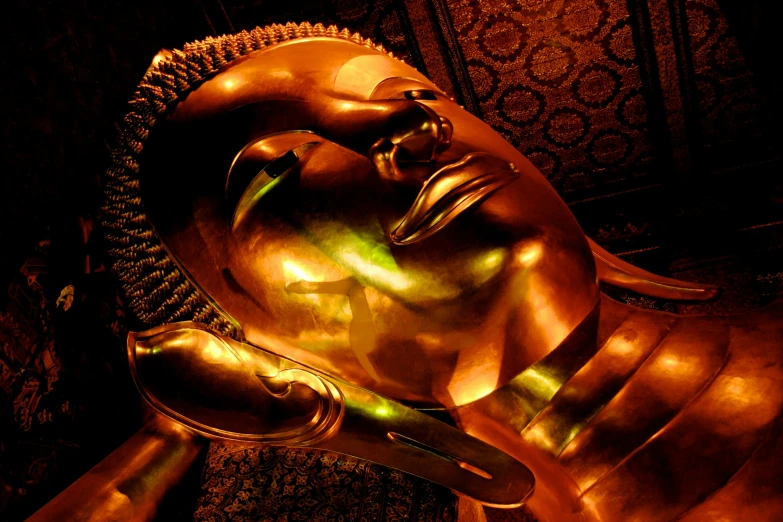 a close - up of a buddha statue with its eyes closed