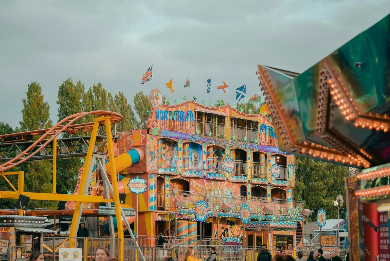 an amut park ride with people standing on the ground