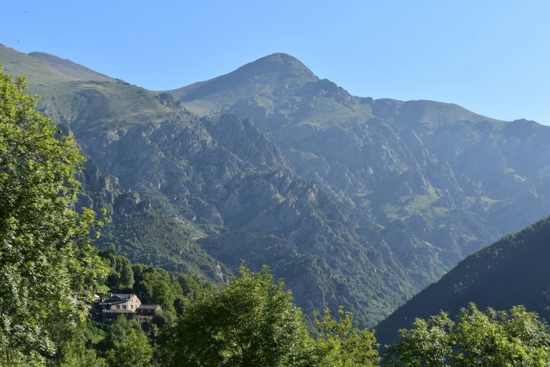 a view of a house in front of the mountain