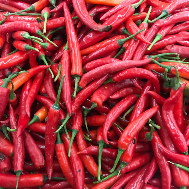 a pile of chili peppers sitting on top of each other