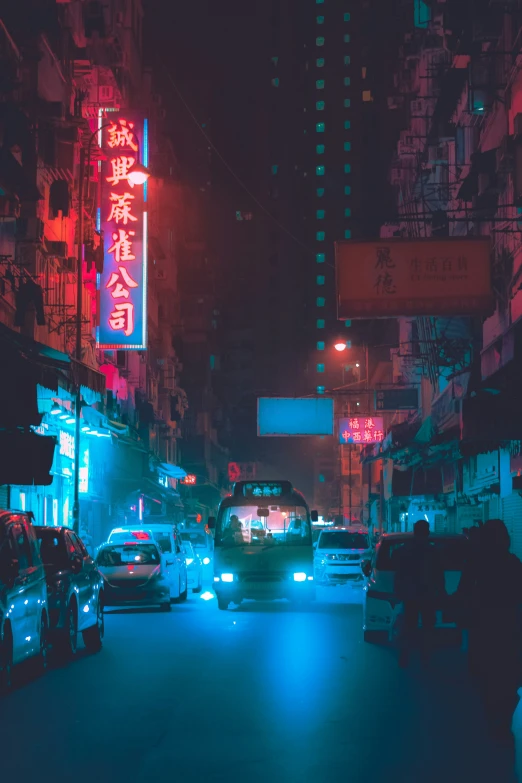 traffic moving down an asian - style city street at night