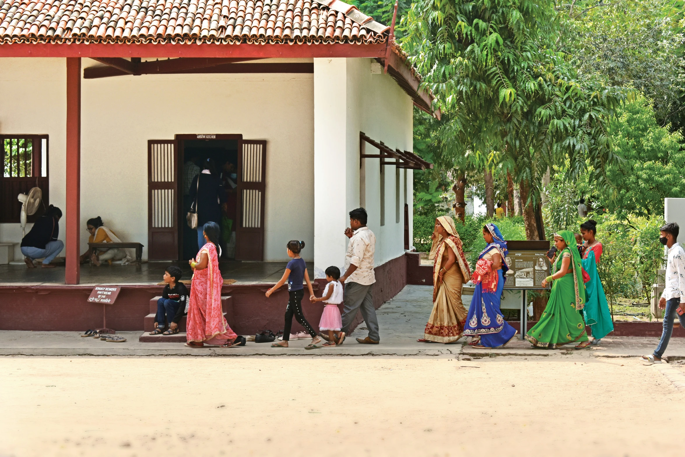 a group of people are in front of a white building