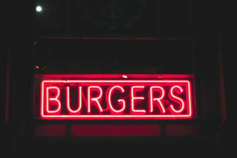 a large red neon sign reads burgers