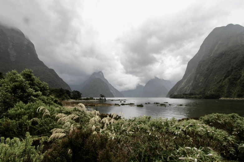 a small body of water with mountains on either side