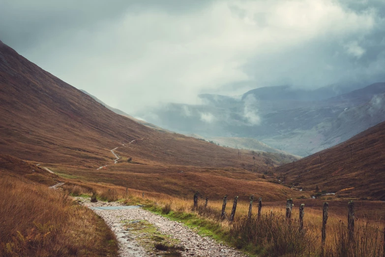 a narrow path in the mountains of a large mountain range