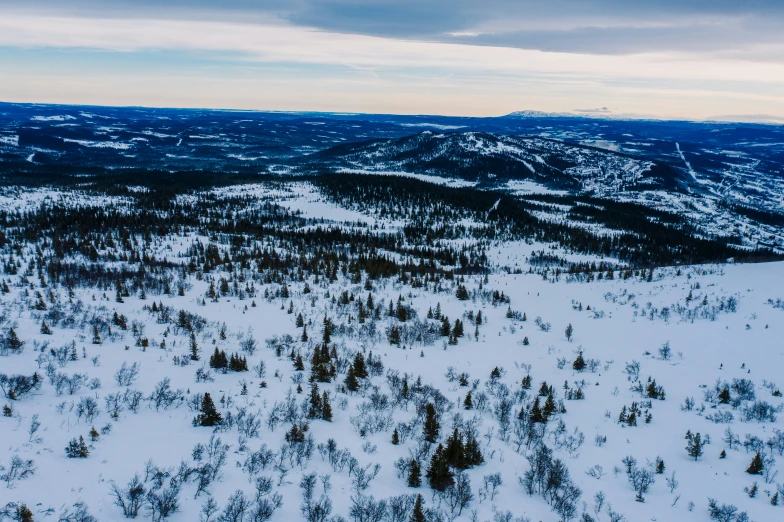 an aerial view of the snowy landscape near the top of a mountain