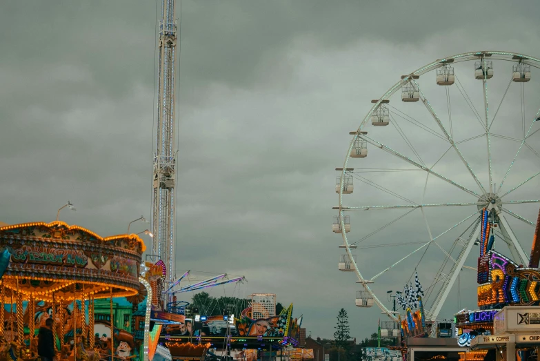 a ferris wheel with an amut park carousel and rides
