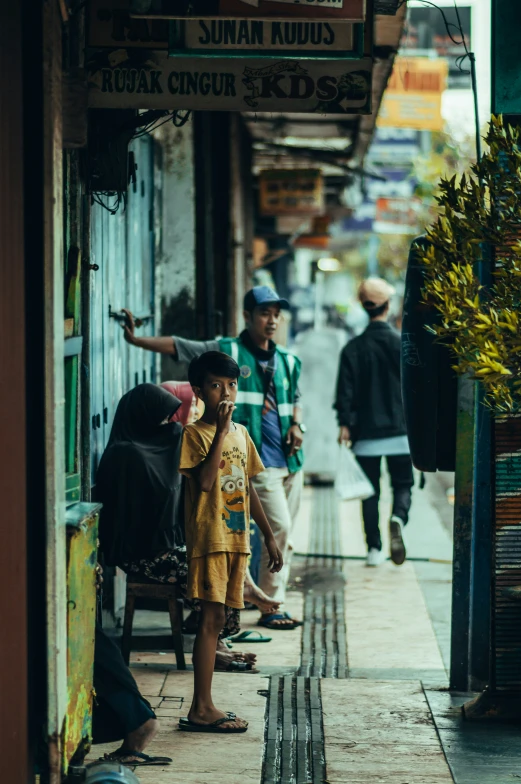 a couple of men and a boy standing on a sidewalk