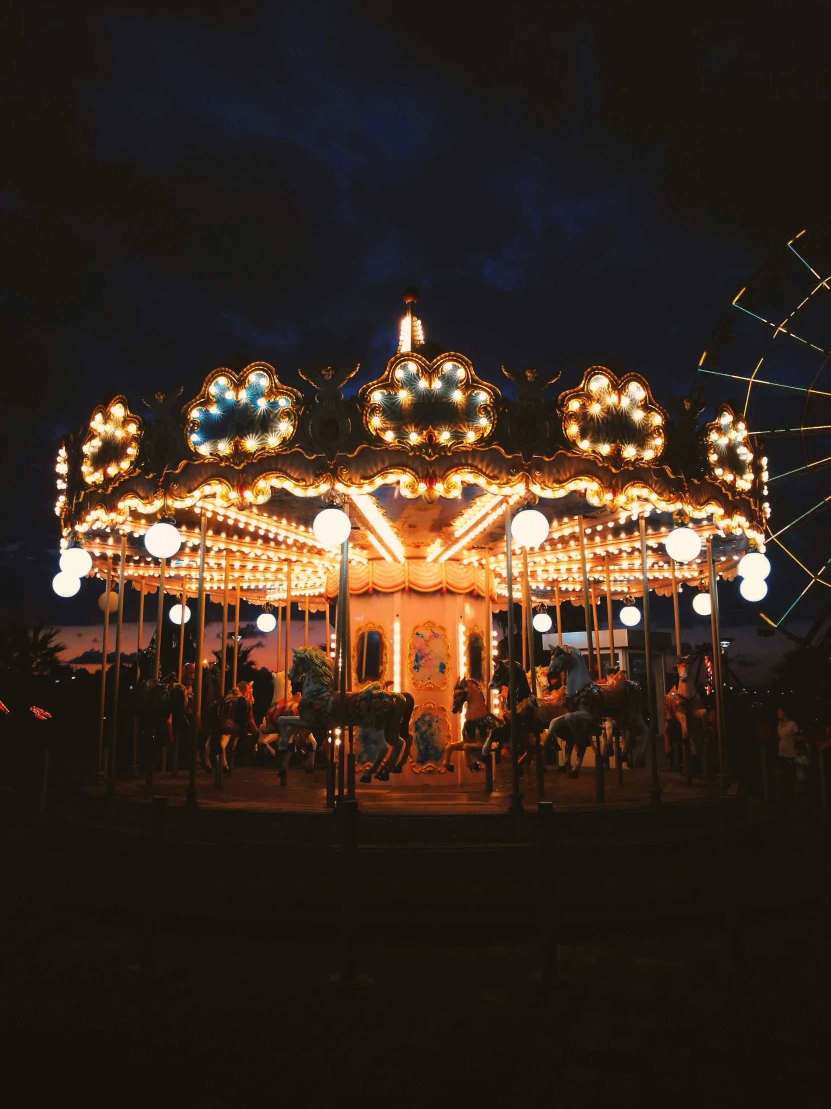 a merry go round at night with lights on