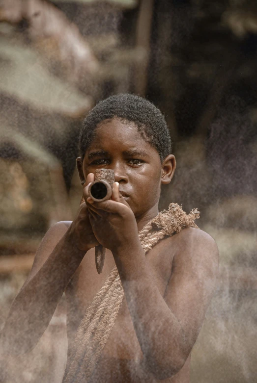 a child holding a camera while wearing no pants