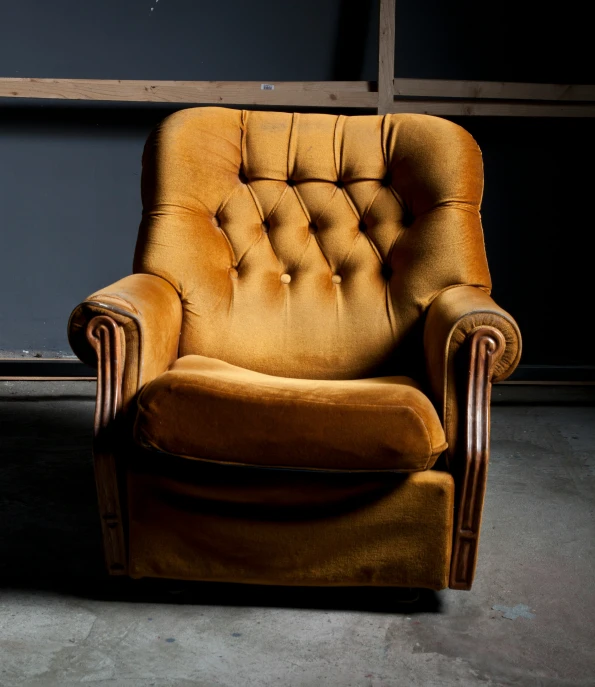 an old yellow chair with dark gray walls