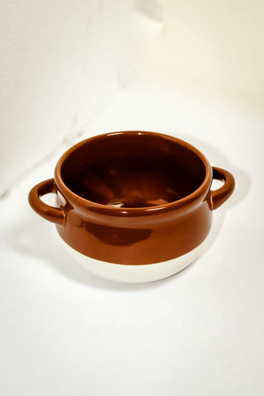 an orange ceramic bowl with white rim