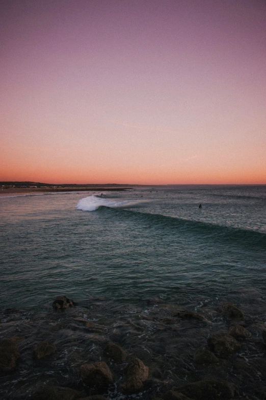 ocean water during the day with a pink sky