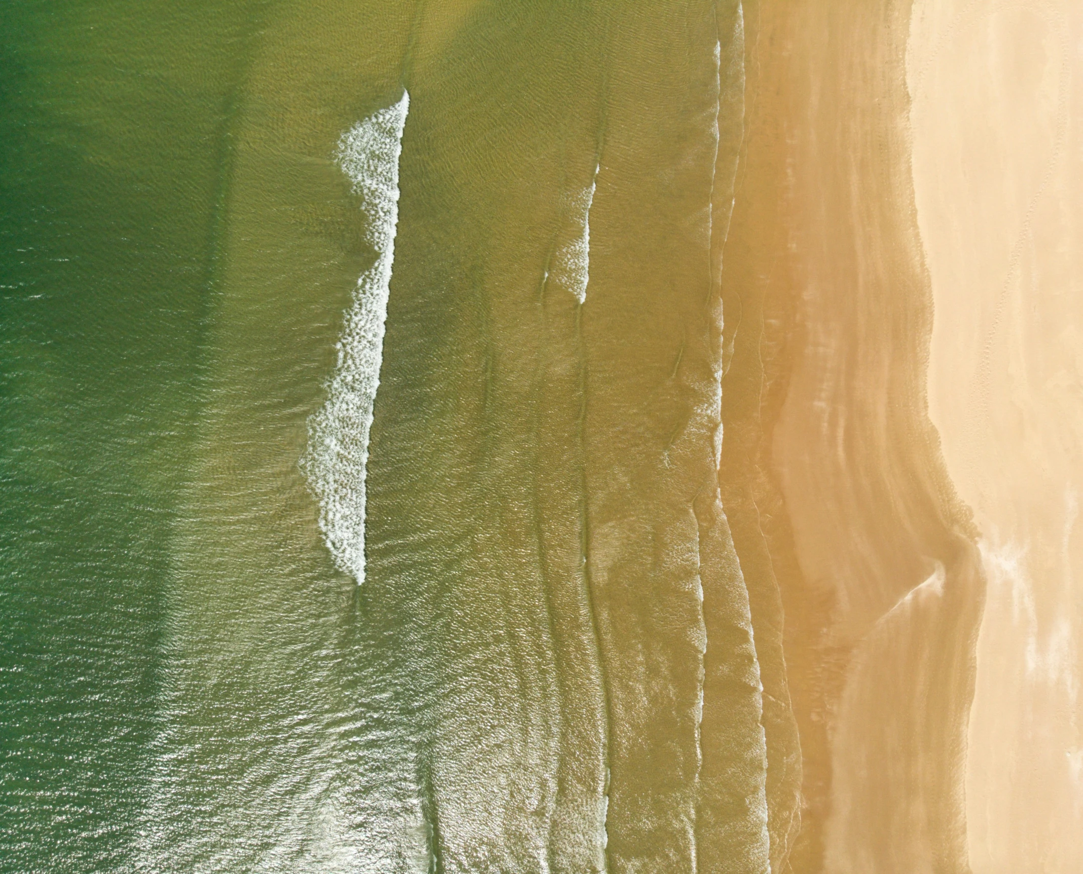 an aerial view of a beach and sandy shoreline