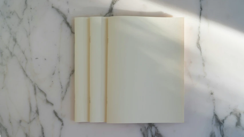 an open book lies on top of a marble counter
