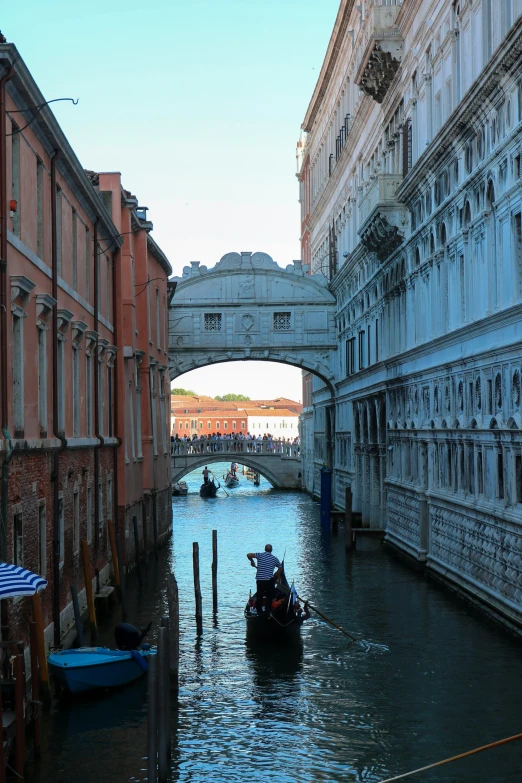 a boat on a river passing under a bridge