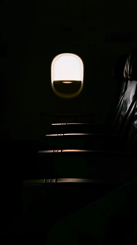 an airplane seat with the sun reflecting off its window