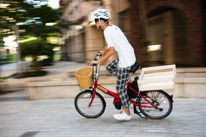 a man riding on a bicycle with a basket next to him