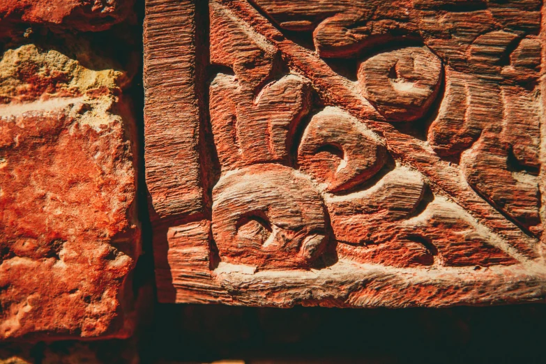 a carved object sitting on top of a stone surface