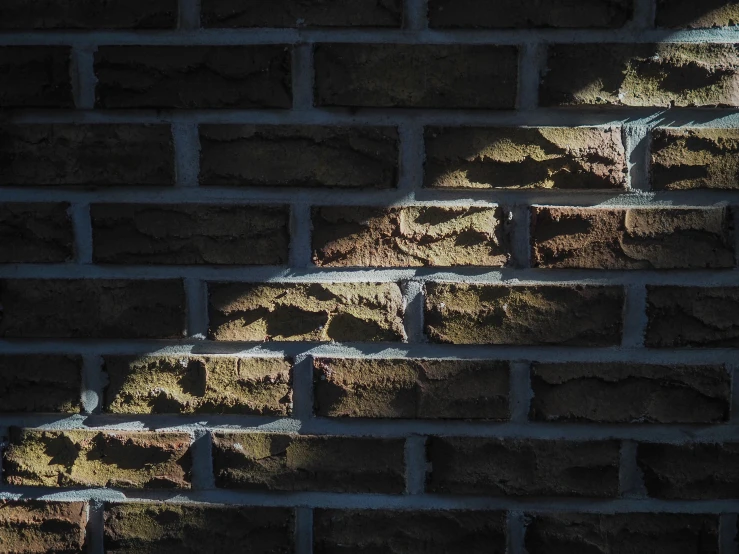 light coming through the gap in a brick wall