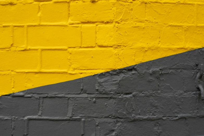a yellow black and white wall with black bricks