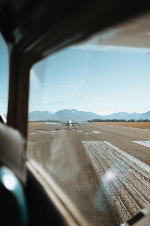 the view out the windshield of an aircraft in a flat landscape