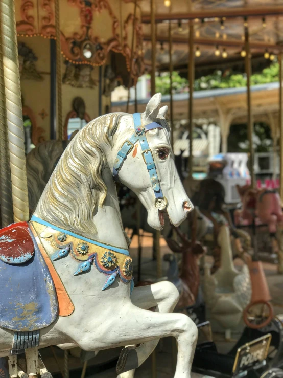 a carousel with horses and people riding on them