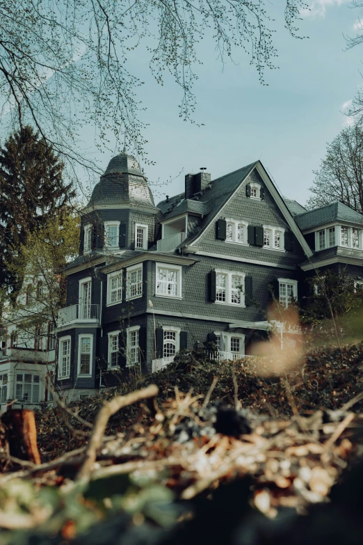 an old house stands tall on top of the hill