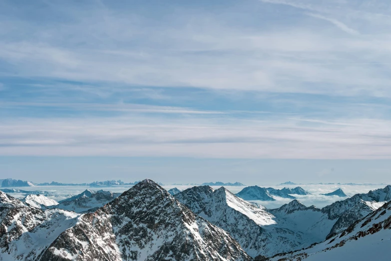 a skier jumps down a hill in the mountains