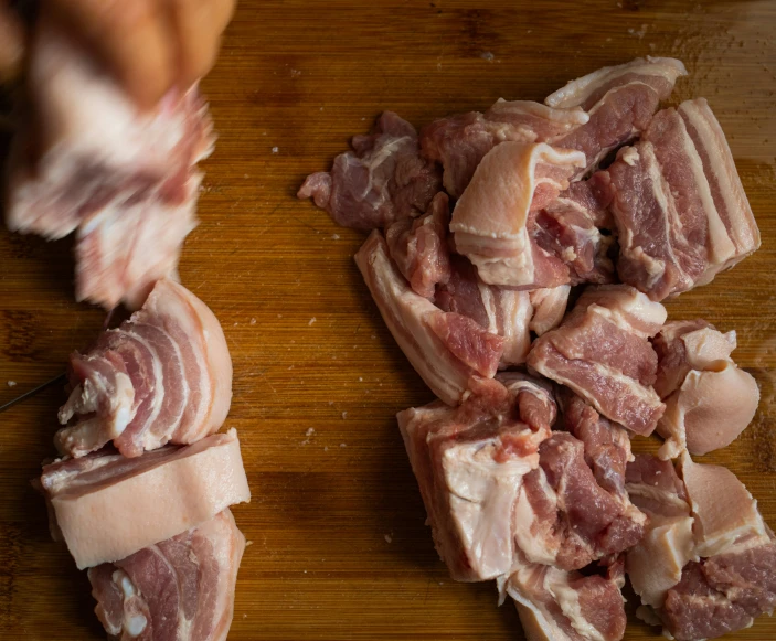 a pile of bacon on a  board with a knife