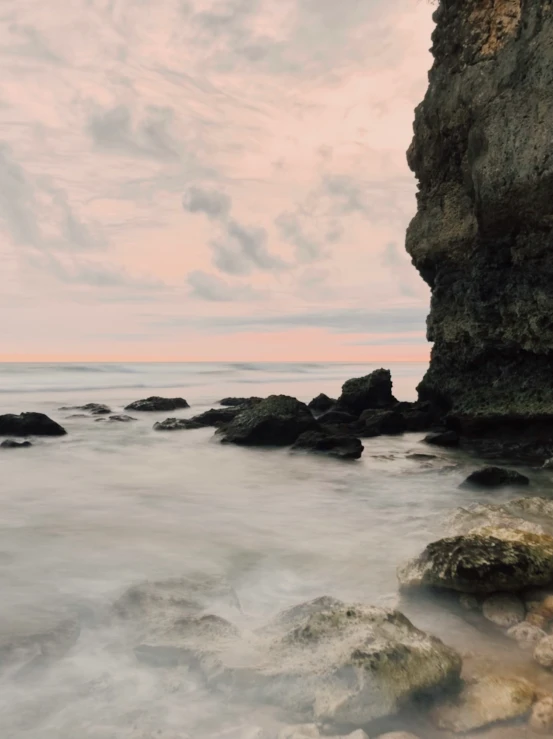 a beach with rocky formations and a view into the ocean