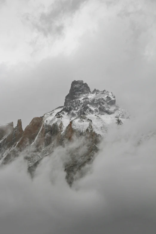 a mountain peak in the midst of clouds