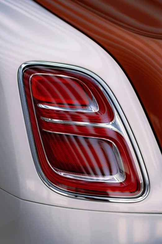 an elegant red and white car with a hood emblem