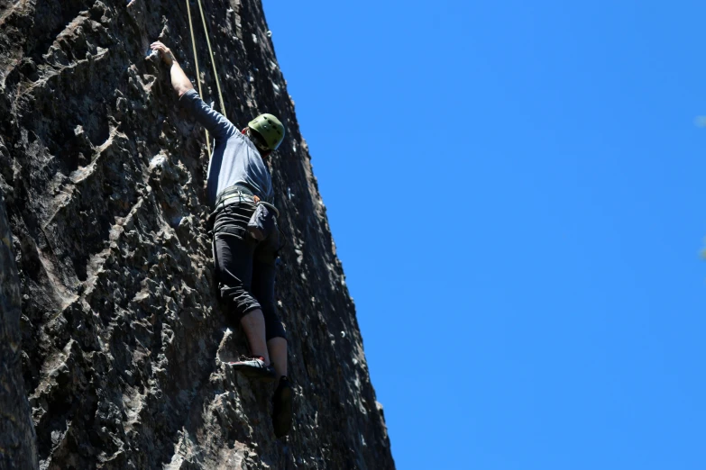 a man rock climbing up the side of a mountain