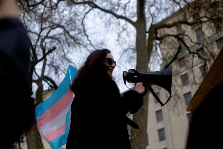 a woman holding a sign and a megaphone