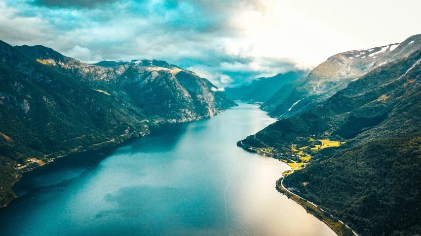 an aerial view of a lake surrounded by mountains and hills