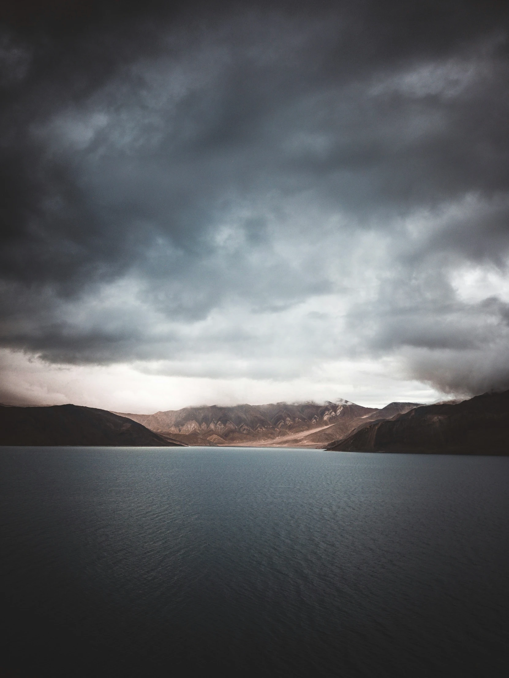 a stormy sky that is over some water