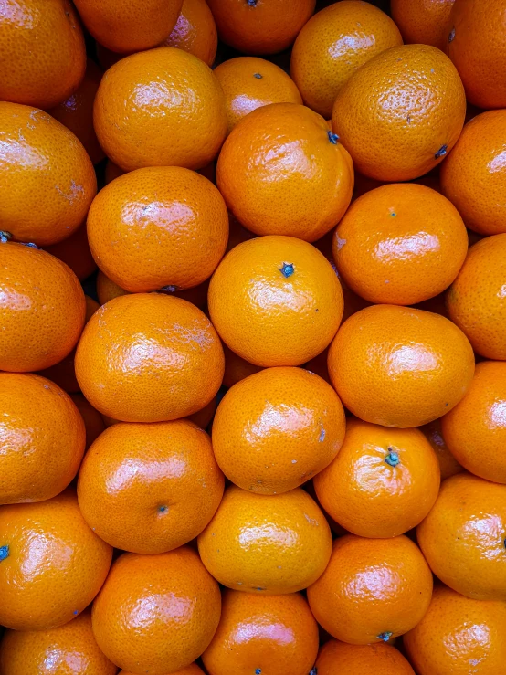 a large pile of oranges stacked on top of each other